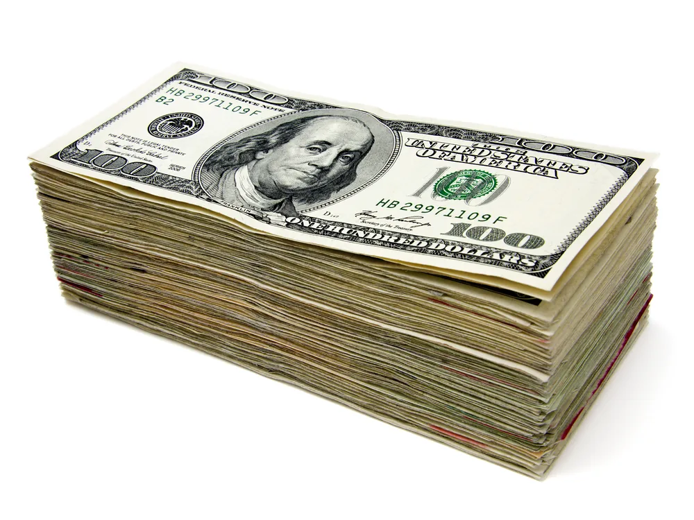A fan of US dollar banknotes, the amount being sent in a remittance